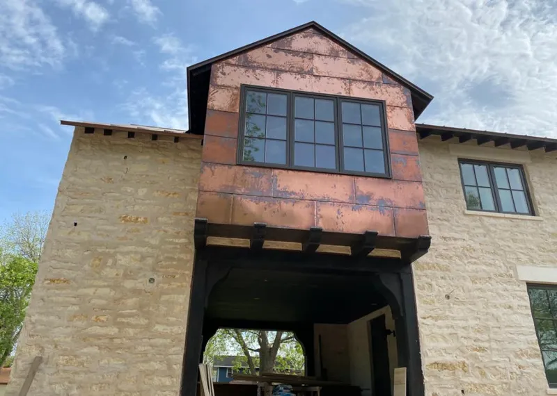 Copper metal panel facade on a stone building for Skylight Installation in Lake Tapps